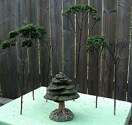 You'll see that I decided to let two of the branches stick with the dead tree look. The moral is that if my goofed-up trees look this good, just think how good yours will look if you use the right combination of green stuff and adhesive.  Click for bigger photo.